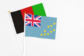 Tuvalu and Afghanistan stick flags on white background. High quality fabric, miniature national...