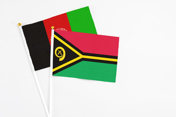 Vanuatu and Afghanistan stick flags on white background. High quality fabric, miniature national...