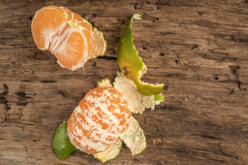 peeled fresh and ripe tangerine on a wooden table