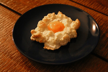The whipped fried egg on a blue dish