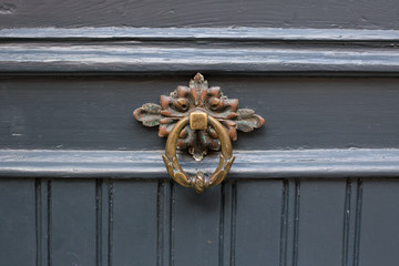 Antique brass door knocker in the shape, door element with metal knob. A very old door handle and...
