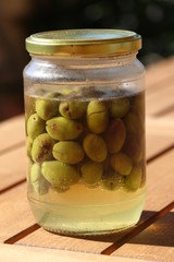 Mediterranean diet: Green and black preserved Cretan olives, homemade in a jar. Healthy diet concept.