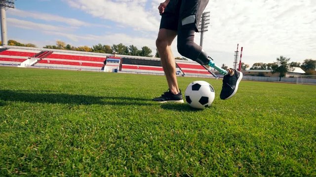 Paralympian is playing football in slow motion