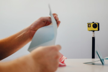 The man is recording a video with instructions on how to fold origami. Influencer concept,...