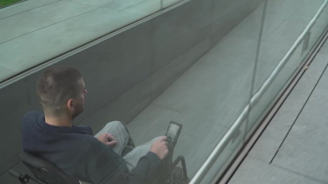 4k resolution follow of a man on electric wheelchair using a ramp. Accessibility concept