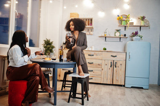 Two African American Female Friends Women Spending Time At Kitchen With Wine. Black Girlfriends  Relaxing At Home.