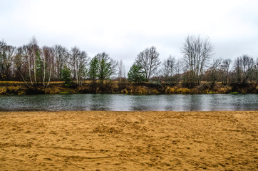 Autumn landscape of deserted beach. Cloudy autumn weather in nature.