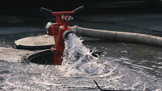 A stream of water from a fire hydrant. Close-up. Fire extinguishing. Firefighters equipment. People safety