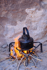 A pot of tea over the fire.