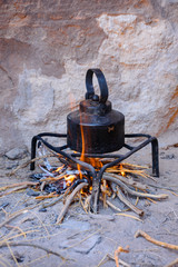 an iron kettle on bonfire