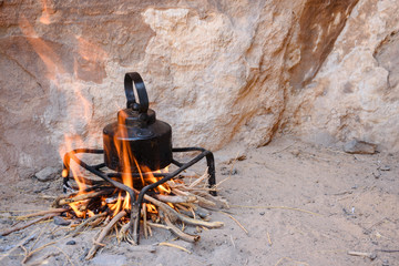 an iron kettle on bonfire