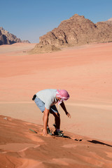 A man riding a sandboarding.