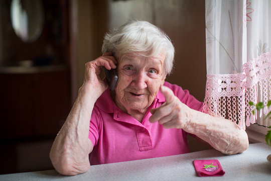 Elderly Russian Woman Talking On Mobile Phone.