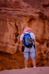A man standing on a rock background.