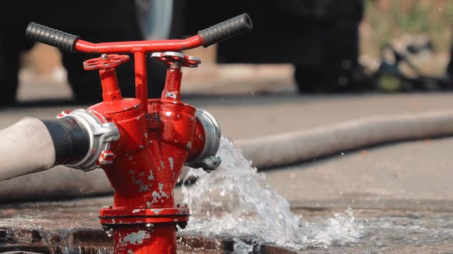 A stream of water from a fire hydrant. Close-up. Fire extinguishing. Firefighters equipment. People safety