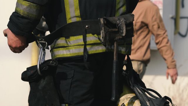 Firefighter in equipment after putting out a fire. Close-up. Fire alarm