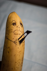 Banana stabbed with a knife