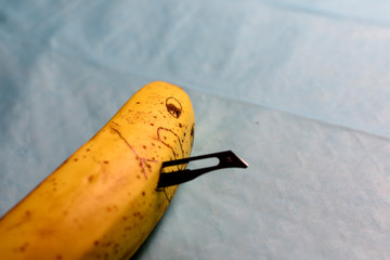Banana stabbed with a knife