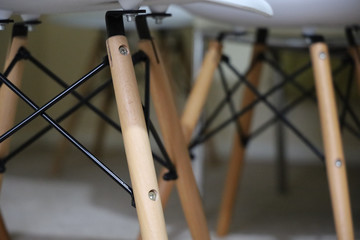Legs of the modern minimalist dinning chairs in shallow depth of field