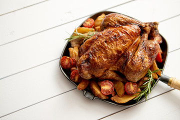 Roasted whole chicken in cast iron black pan