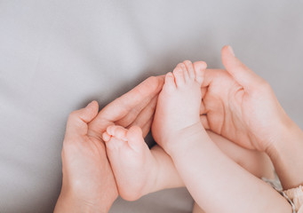 little baby lies parents touch gently legs