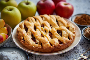 Fresh baked tasty homemade apple pie cake with ingredients on side