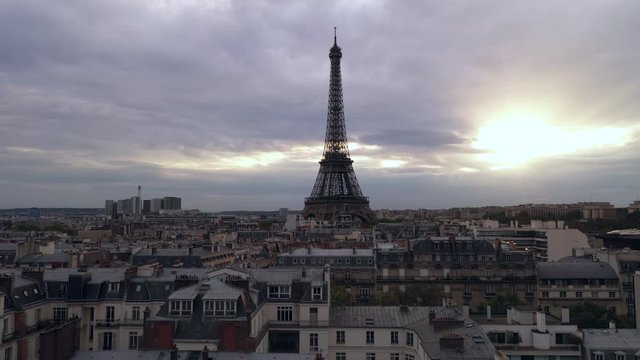 Aerial cityscape of Paris France and Eiffel Tower during sunset panning left.