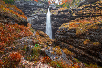 Beautiful Pericnik waterfall in autumn colors on forest in Triglav National Park, Slovenian Alps