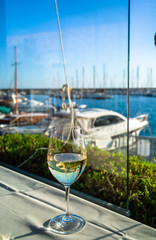 glasses of wine on a table in a restaurant with sea view