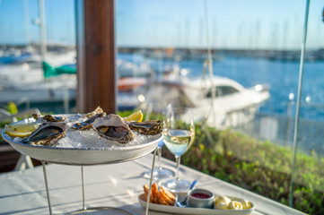 dish with oysters on a table in a restaurant with sea view