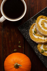 Pumpkin Roll with powdered sugar with walnuts and pumpkin seeds and cup of coffee