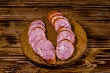 Cutting board with sliced sausage on a wooden table