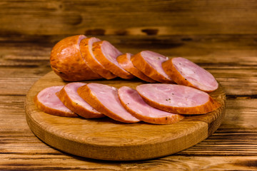 Cutting board with sliced sausage on a wooden table