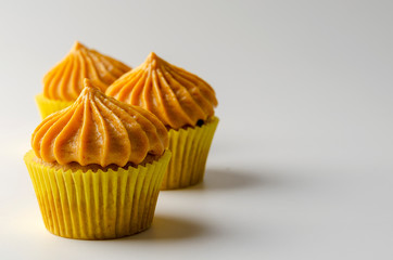 Pumpkin cupcakes with pumpkin-caramel cream Isolated on a White Background