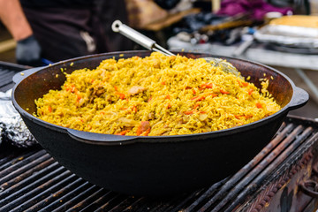 Big pan with pilaf on street festival