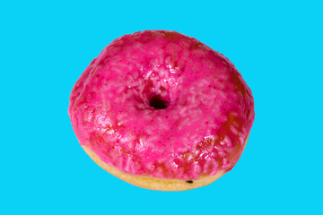 Donut with glazed top isolated on a blue background