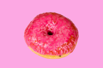 Donut with glazed top isolated on a pink background
