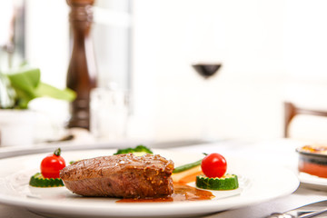 steak with tomtao and pepper mit in background