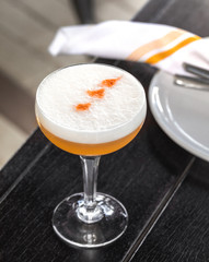 fresh orange alcohol cocktail at a restaurant interior 