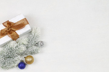 The christmas background with spruce branch, balls and gift box. New Year.