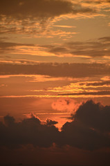 A vibrant orange coloured stratocumulus cloudy sunrise. A nature sky image