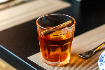 fresh brown color whiskey with cinnamon alcohol cocktail at a restaurant interior 