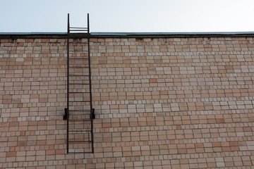 fire escape, fire ladder on the wall of the building, the concept of fire safety, fire action and...
