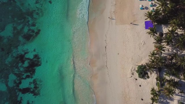 Beautiful tropical beach top view. Aerial drone shot of turquoise sea water at the beach.