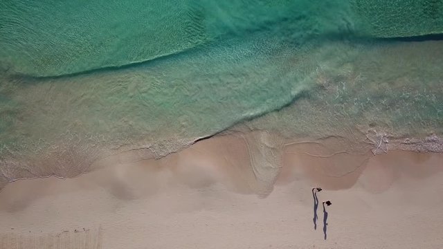 Beautiful tropical beach top view. Aerial drone shot of turquoise sea water at the beach.