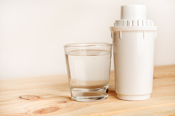 filter for cleaning tap water for drinking and a glass of filtered clean water