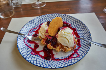 Vanilla Ice Cream Served On a Plate With Wild Berries Dressing And Wafers