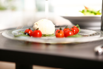 mozzerella and tomatos served on a plate with balsamico