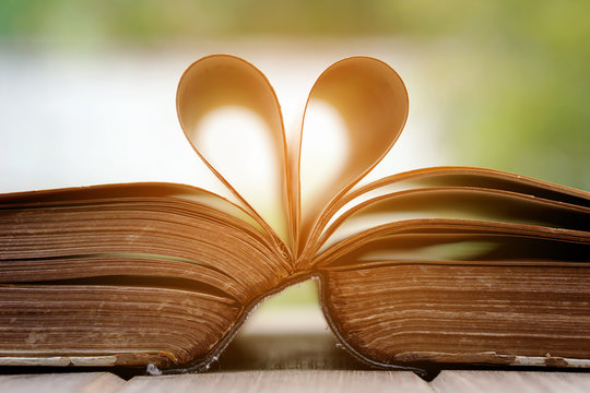 Folding old book to heart shape
