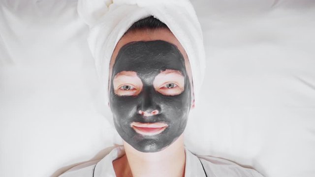 close up face woman with black cosmetic mask wellness, spa, skincare